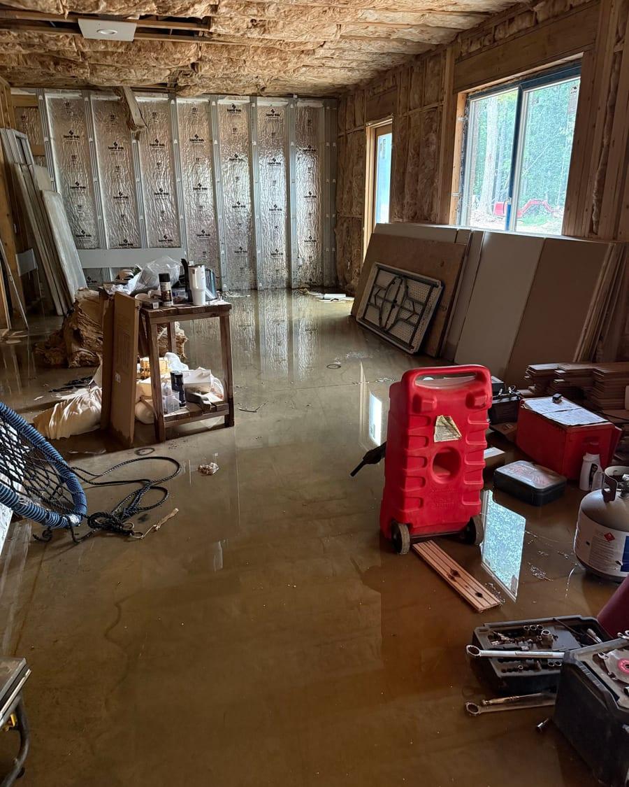 Standing water across a finished basement floor