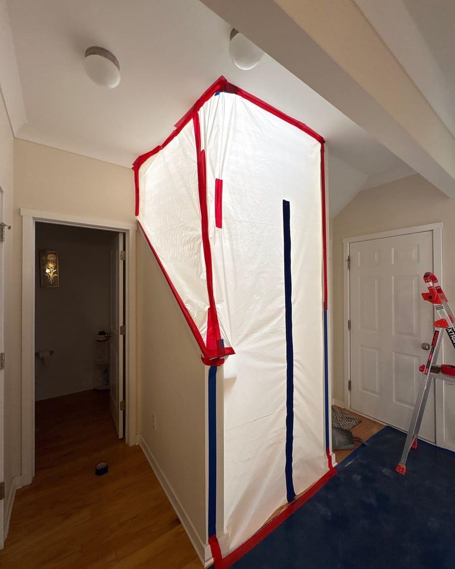A zippered plastic containment wall sealing off part of a hallway