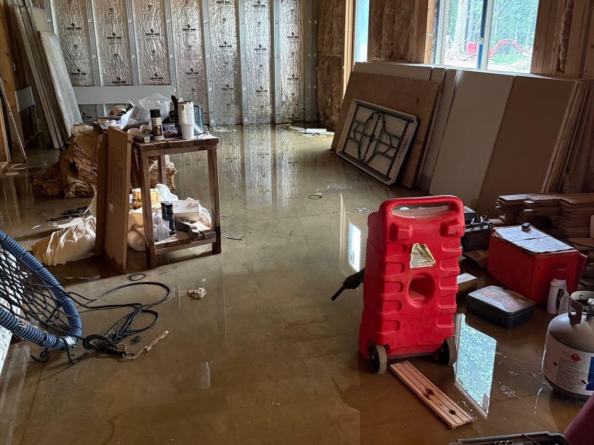 Standing water across a finished basement floor