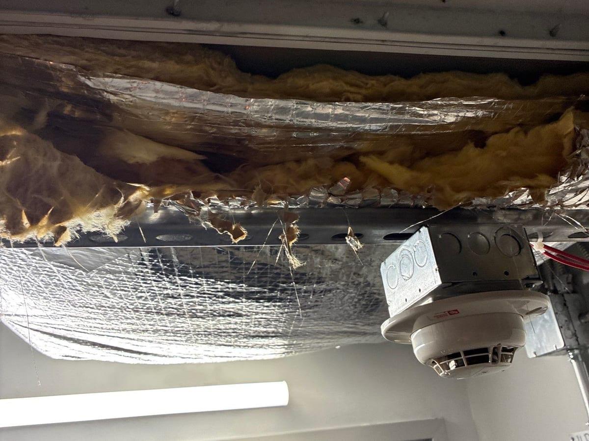 An opened ceiling in a commercial building after water came through