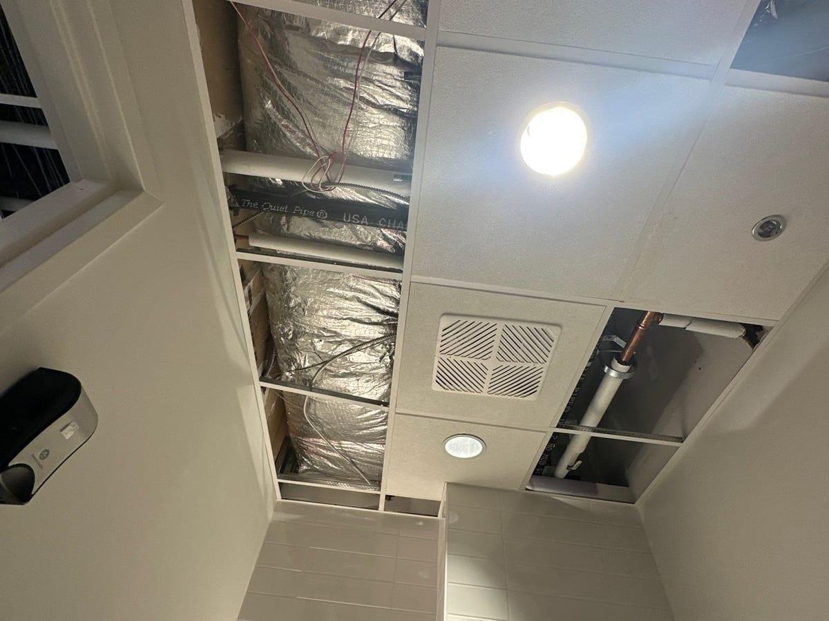 Air movers and dehumidifiers drying an office corridor