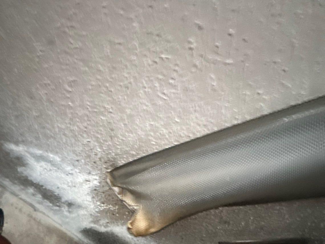Soot spread across a ceiling and ductwork after a fire