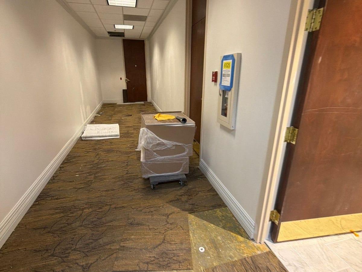 Water across the floor of an office corridor before extraction