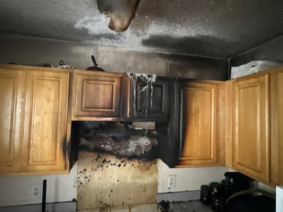 Soot and fire damage across kitchen cabinets and the ceiling