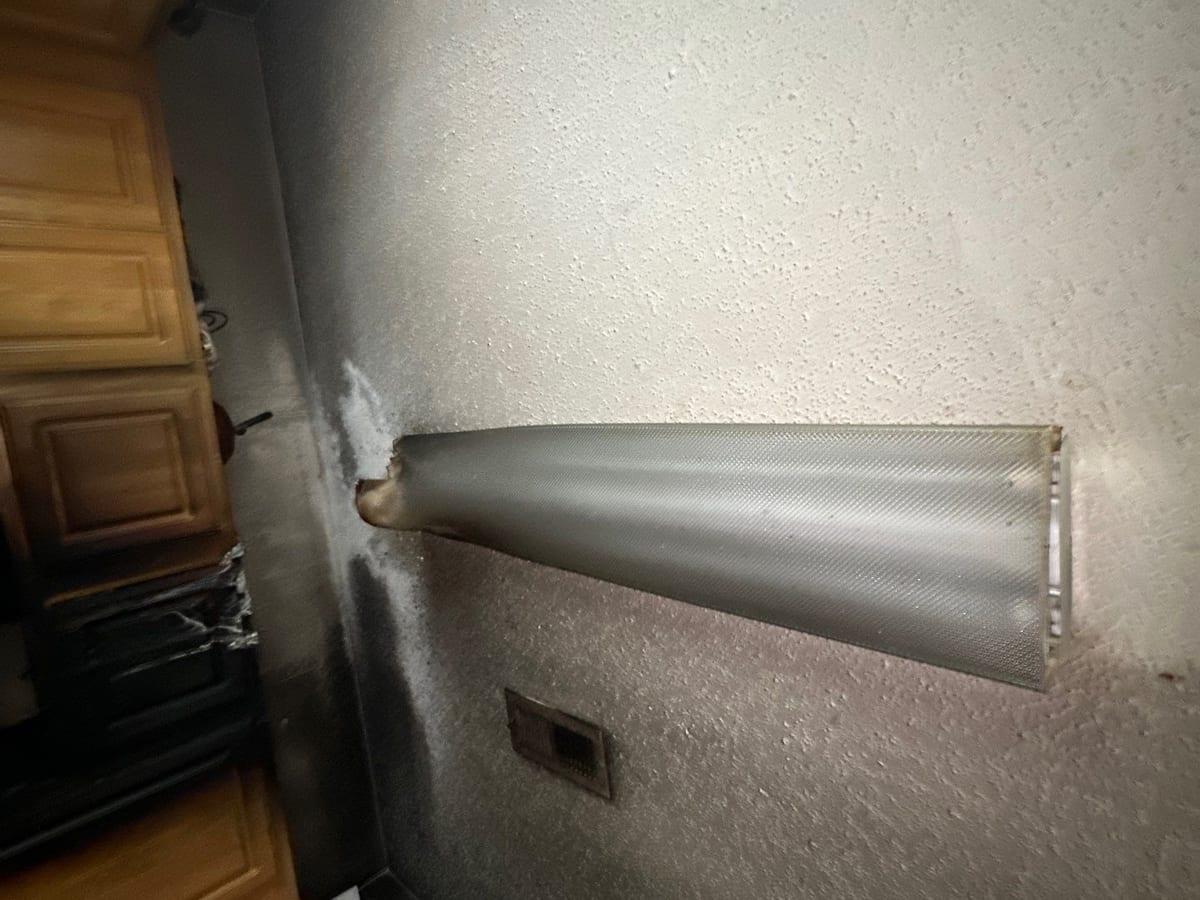 Soot-stained wall and cabinets waiting for repair after a fire