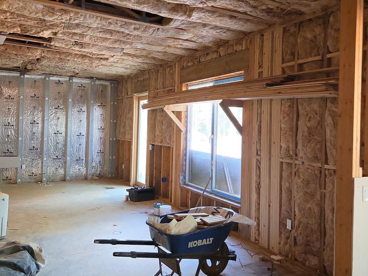 A basement stripped to the framing after water damage, ready for repairs