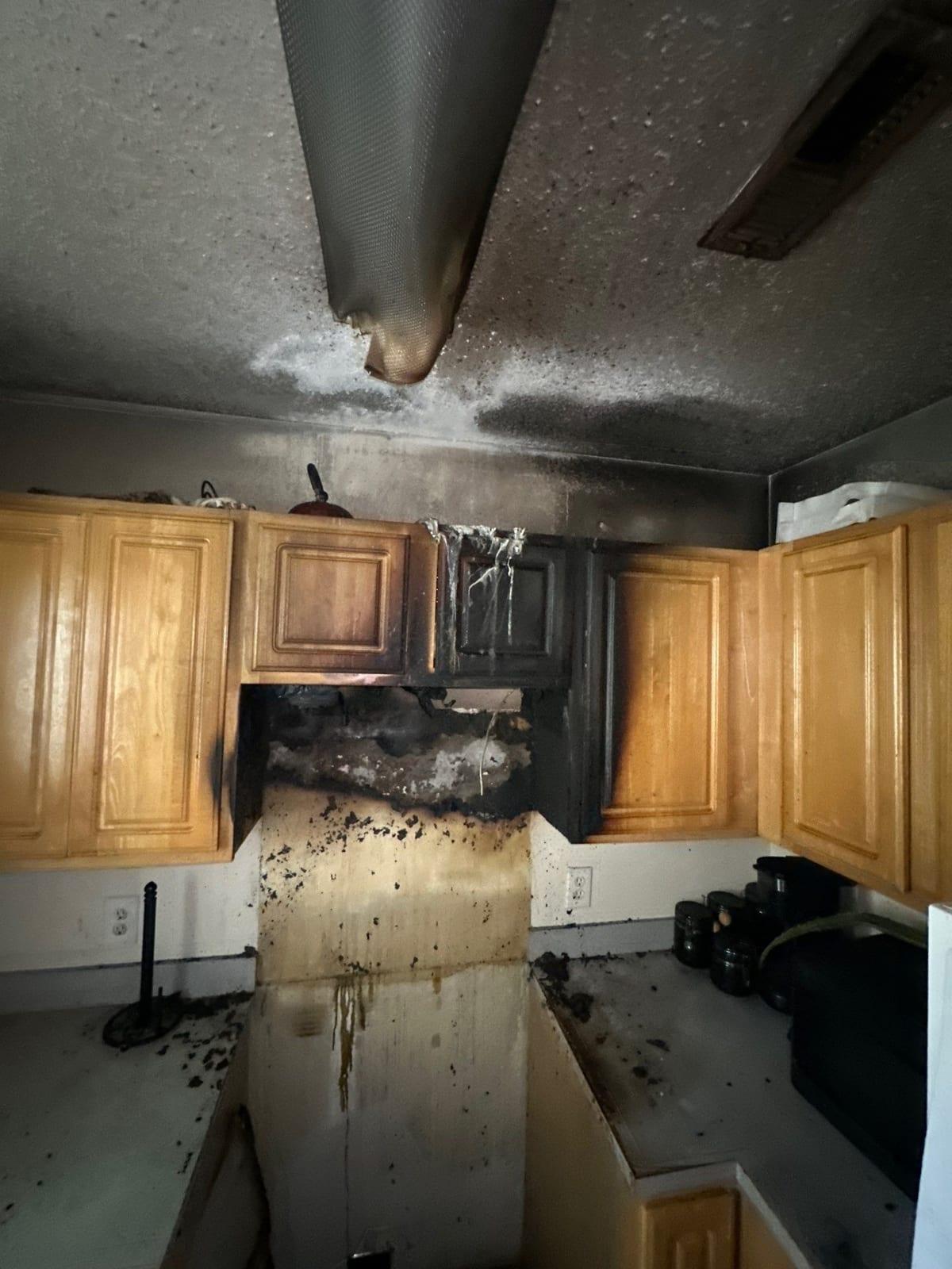 Soot and fire damage across kitchen cabinets and the ceiling